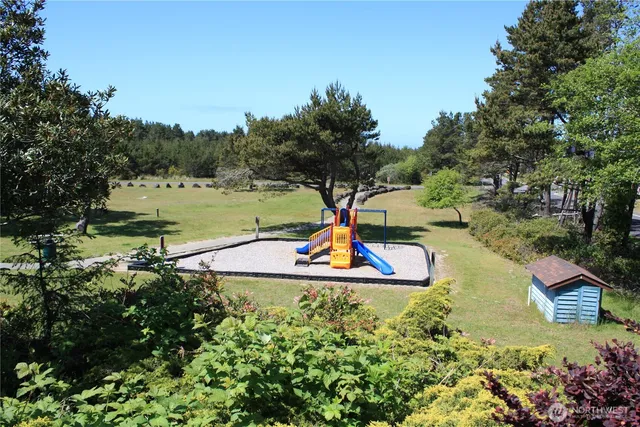 a backyard of a house with barbeque oven table and chairs