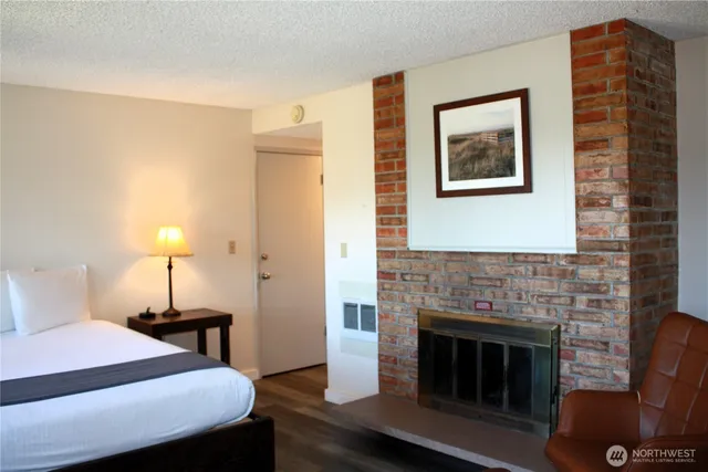 a bedroom with a bed and a fireplace