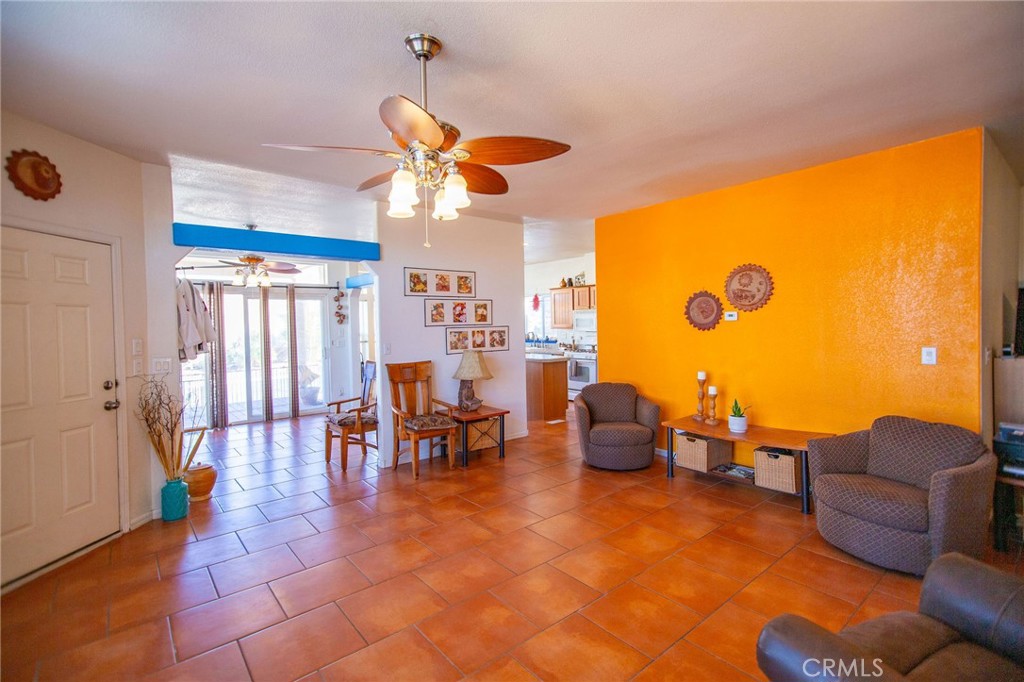 1106 Beach Drive Needles, CA 92363 - Photo 16 of 73 a living room with furniture a chandelier and a floor to ceiling window