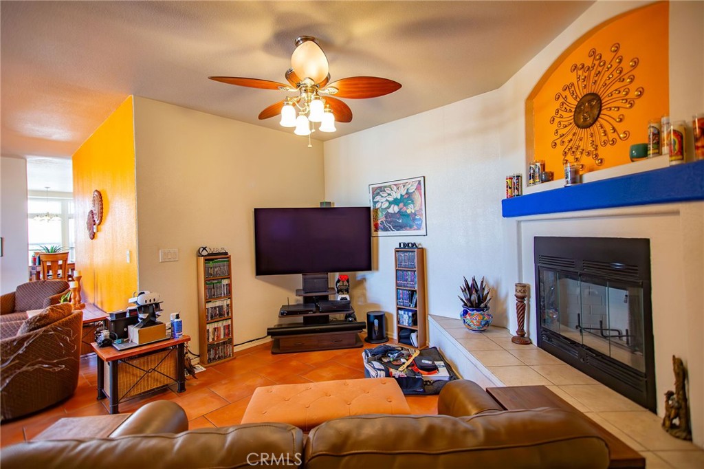 1106 Beach Drive Needles, CA 92363 - Photo 22 of 73 a room with furniture a fireplace and a flat screen tv