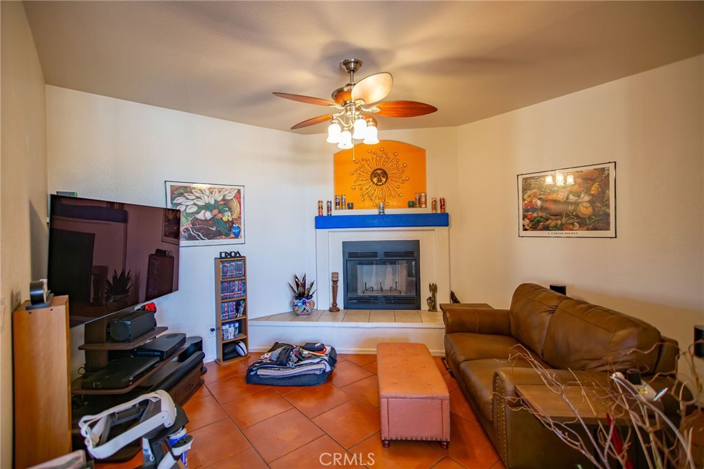 1106 Beach Drive Needles, CA 92363 - Photo 24 of 73 a living room with furniture a flat screen tv and a fireplace