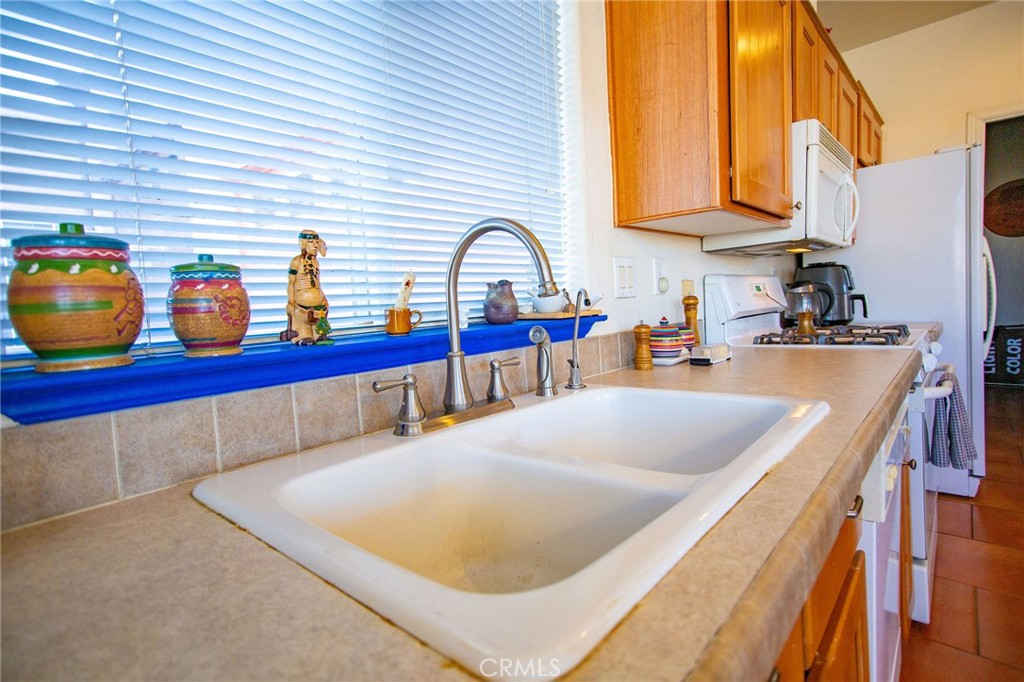 1106 Beach Drive Needles, CA 92363 - Photo 27 of 73 a kitchen with stainless steel appliances granite countertop a sink dishwasher and cabinets with wooden floor