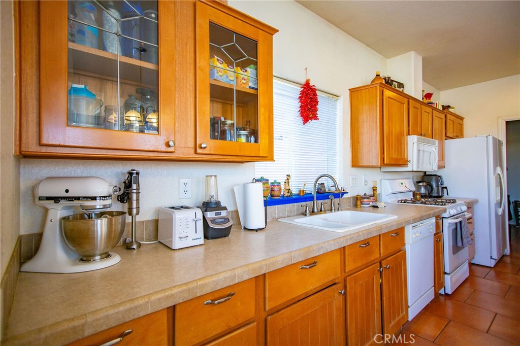 1106 Beach Drive Needles, CA 92363 - Photo 28 of 73 a kitchen with sink cabinets and window