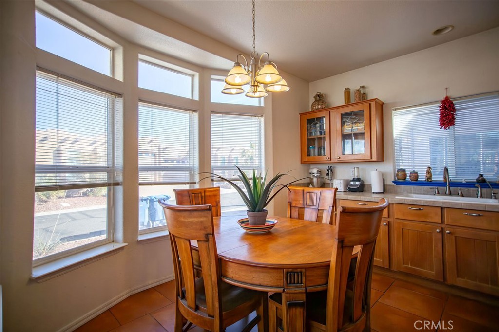 1106 Beach Drive Needles, CA 92363 - Photo 34 of 73 a view of a dining room with furniture a chandelier and wooden floor