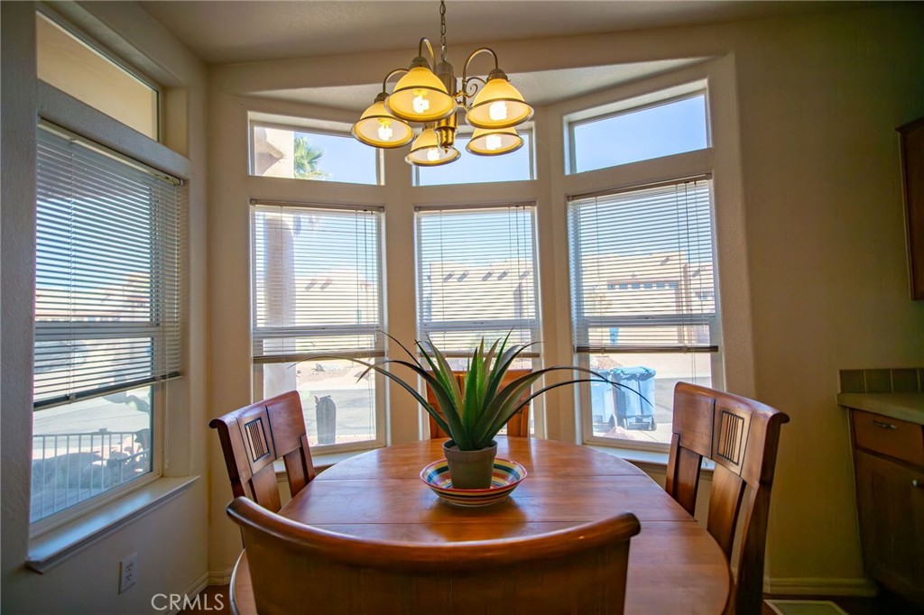 1106 Beach Drive Needles, CA 92363 - Photo 35 of 73 a view of a dining room with furniture a chandelier and wooden floor