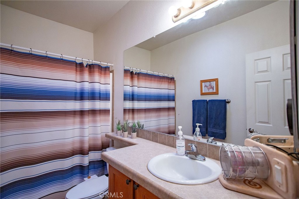1106 Beach Drive Needles, CA 92363 - Photo 40 of 73 a bathroom with a sink and a mirror