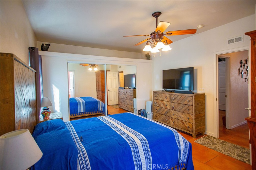 1106 Beach Drive Needles, CA 92363 - Photo 46 of 73 a bedroom with a bed and a flat screen tv