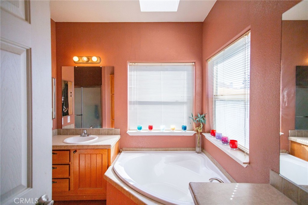 1106 Beach Drive Needles, CA 92363 - Photo 47 of 73 a bathroom with a tub sink and a window