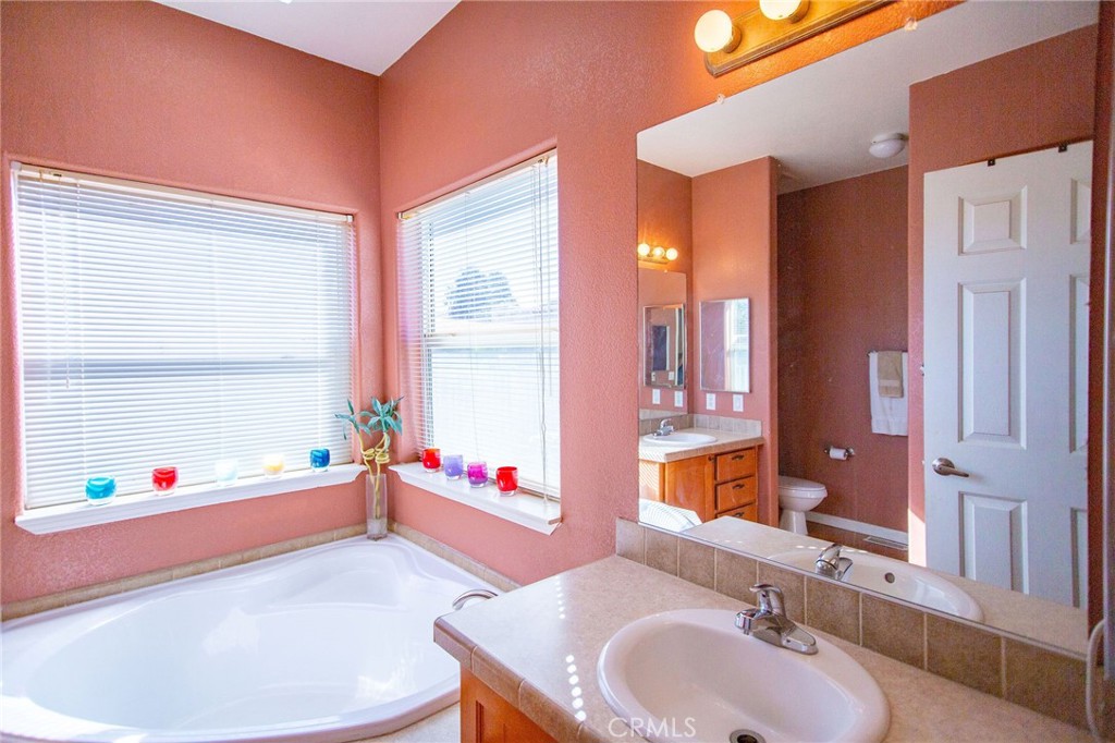 1106 Beach Drive Needles, CA 92363 - Photo 48 of 73 a bathroom with a tub sink and mirror
