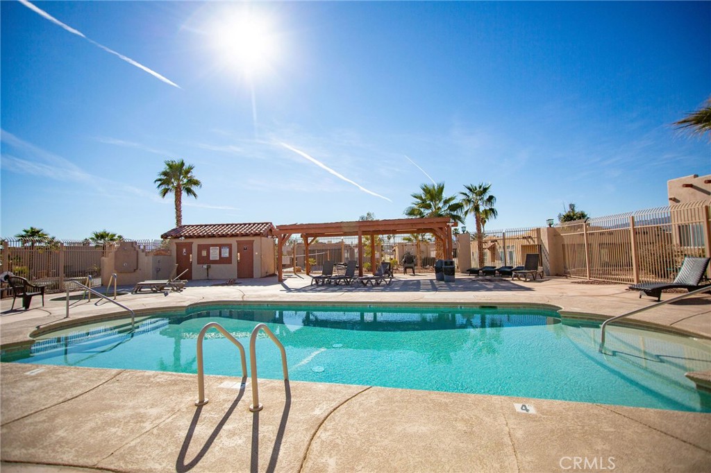 1106 Beach Drive Needles, CA 92363 - Photo 66 of 73 a view of a swimming pool with a lounge chairs