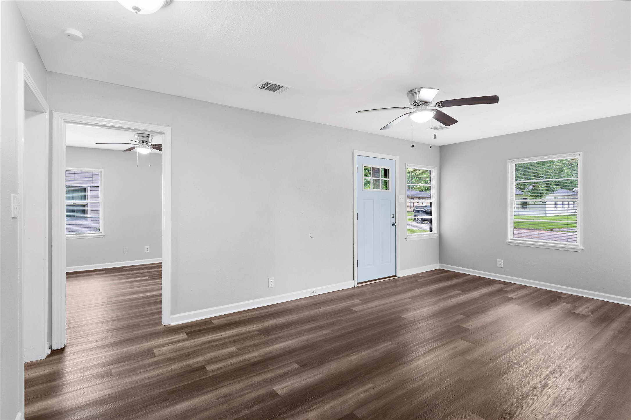 1104 Southampton Drive Angleton, TX 77515 - Photo 4 of 26 a view of an empty room with a window and wooden floor