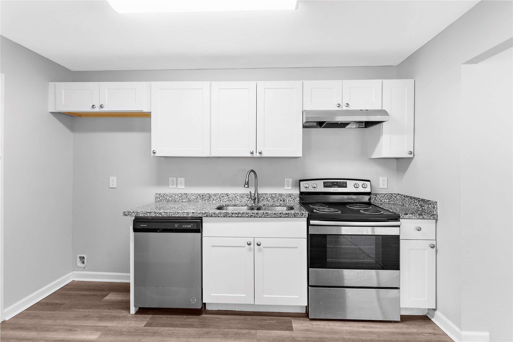 1104 Southampton Drive Angleton, TX 77515 - Photo 8 of 26 a kitchen with stainless steel appliances granite countertop a stove and white cabinets