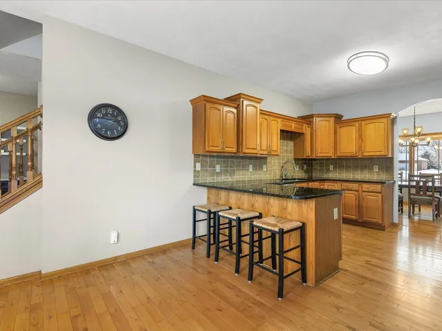 a kitchen with granite countertop a stove a sink and a microwave