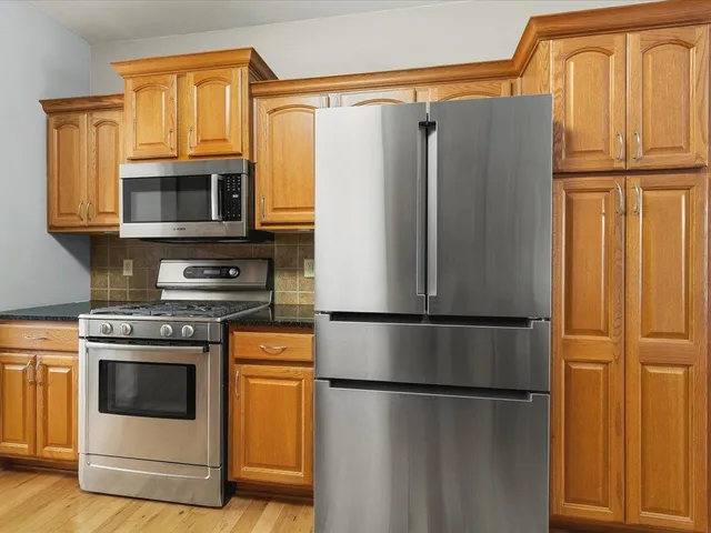 a white refrigerator freezer and a stove top oven