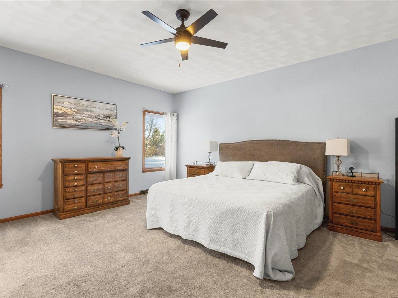 12375 Wildflower Lane Belvidere, IL 61008 - Photo 21 of 52 a bedroom with a bed a dresser and a chandelier