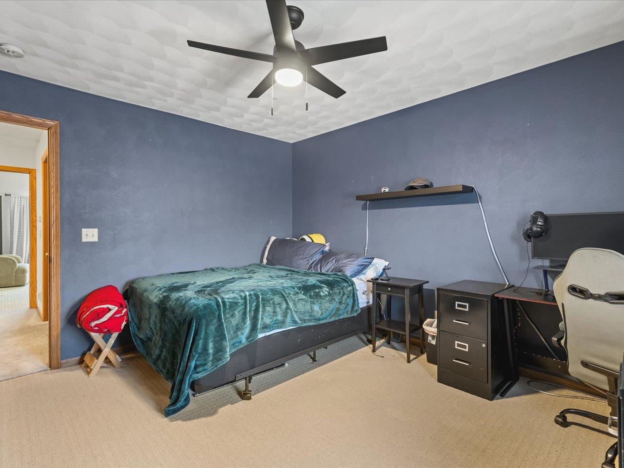 12375 Wildflower Lane Belvidere, IL 61008 - Photo 35 of 52 a bedroom with a bed and a chandelier