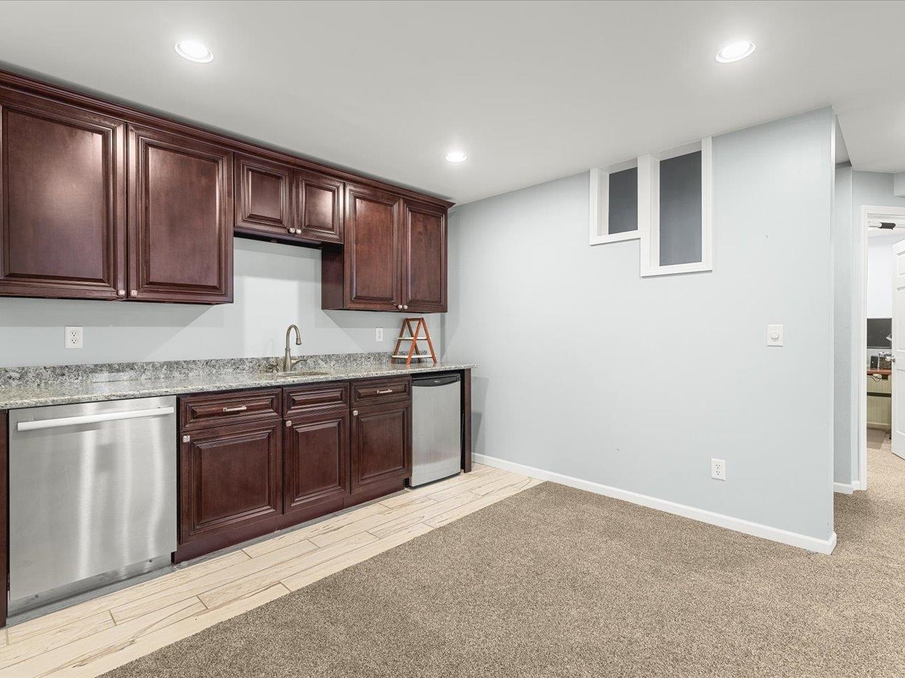 12375 Wildflower Lane Belvidere, IL 61008 - Photo 39 of 52 a kitchen with granite countertop wooden cabinets a sink and dishwasher