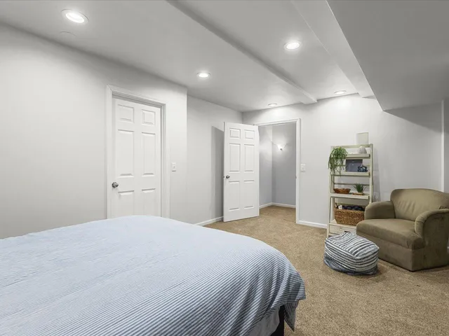 a spacious bedroom with a bed and furniture