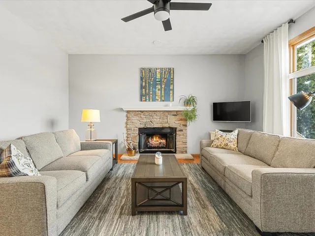 a living room with furniture and a fireplace
