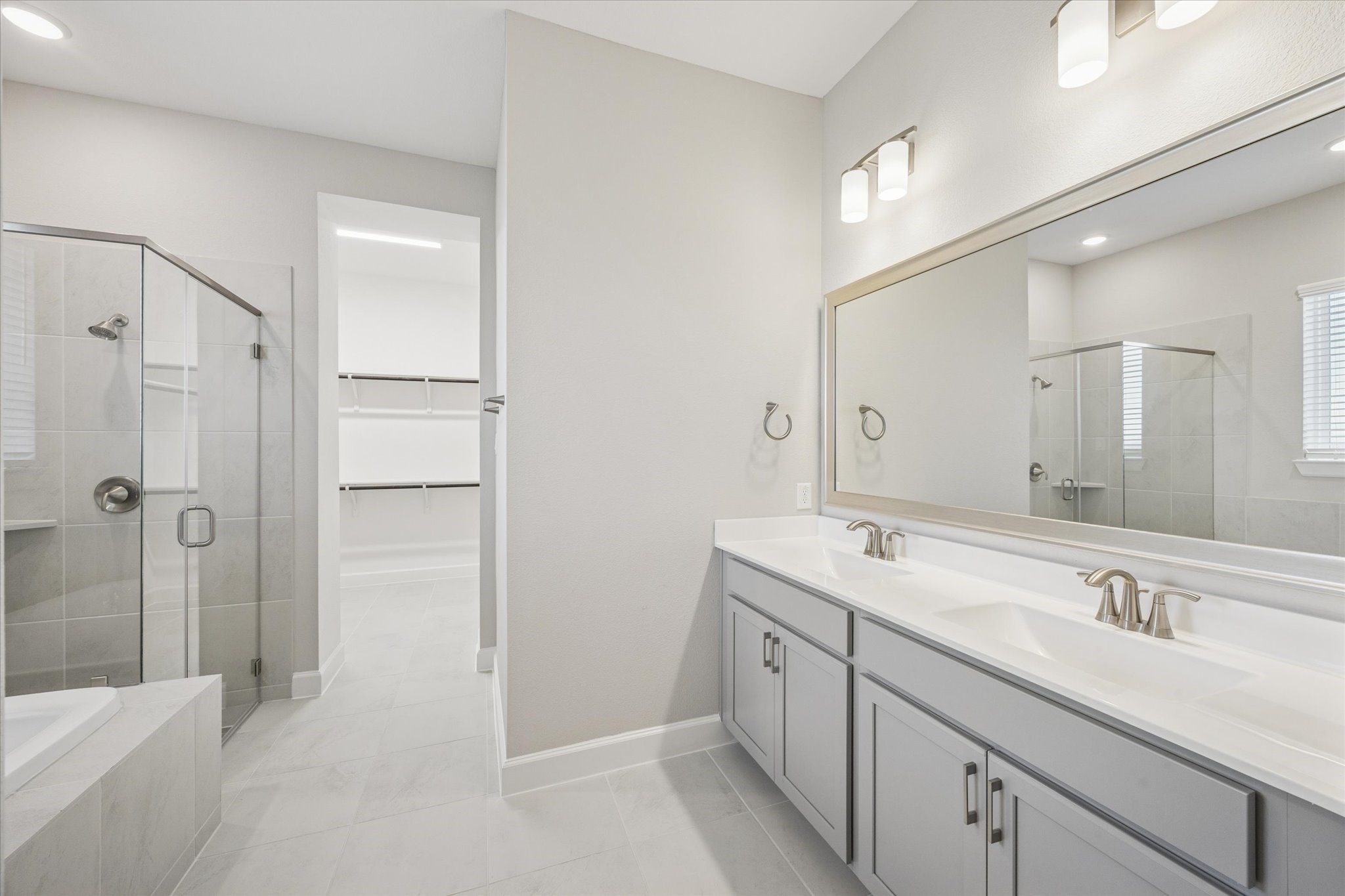 5518 Kindle Alley Manvel, TX 77578 - Photo 11 of 20 a spacious bathroom with a shower sink double and mirror