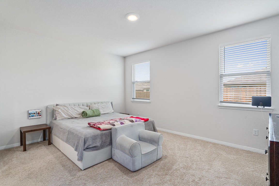 204 Connor Lane Georgetown, TX 78626 - Photo 14 of 31 a bedroom with a bed and a couch