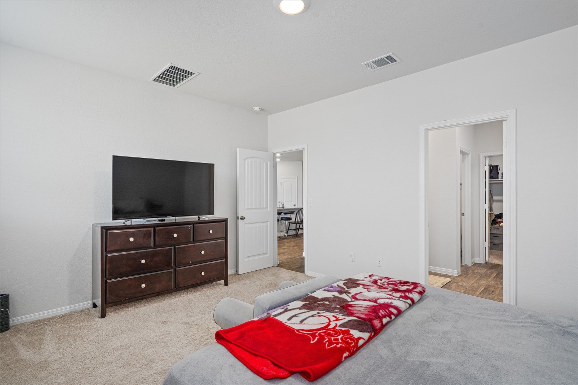 204 Connor Lane Georgetown, TX 78626 - Photo 15 of 31 a bedroom with a bed and flat screen tv