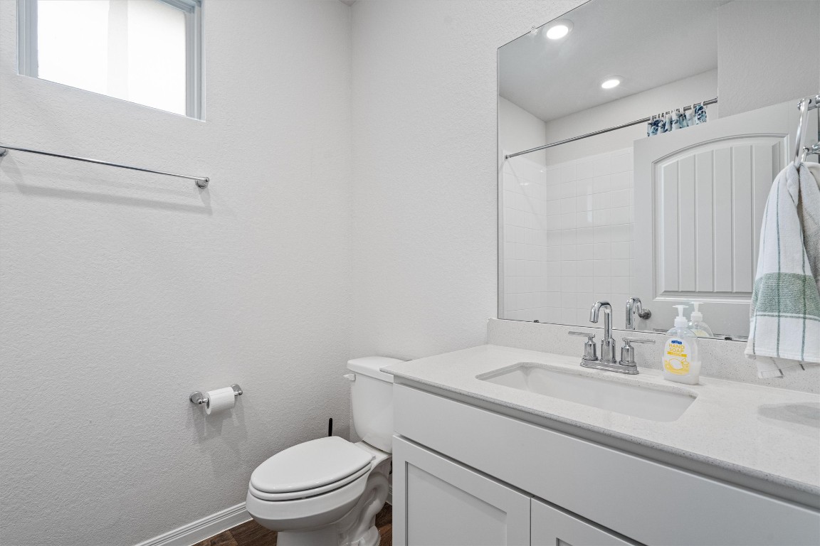 204 Connor Lane Georgetown, TX 78626 - Photo 23 of 31 a bathroom with a sink a toilet and a mirror