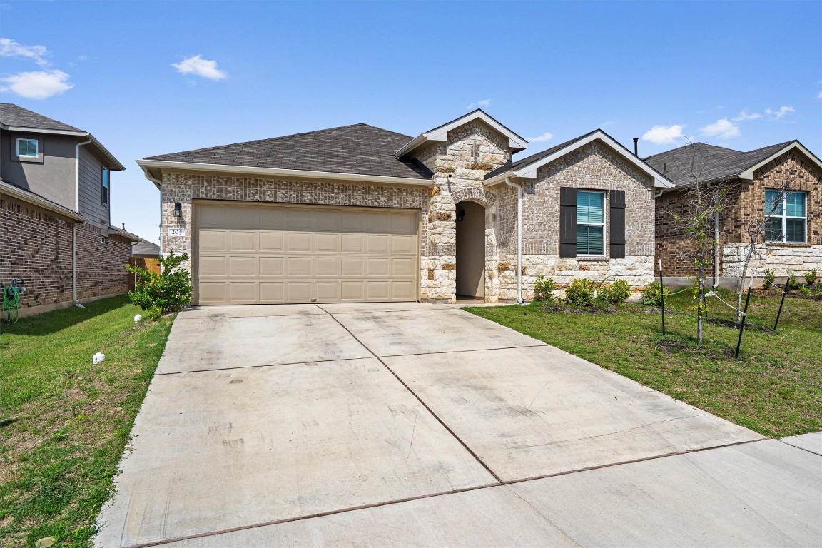 204 Connor Lane Georgetown, TX 78626 - Photo 3 of 31 a front view of a house with a yard and garage