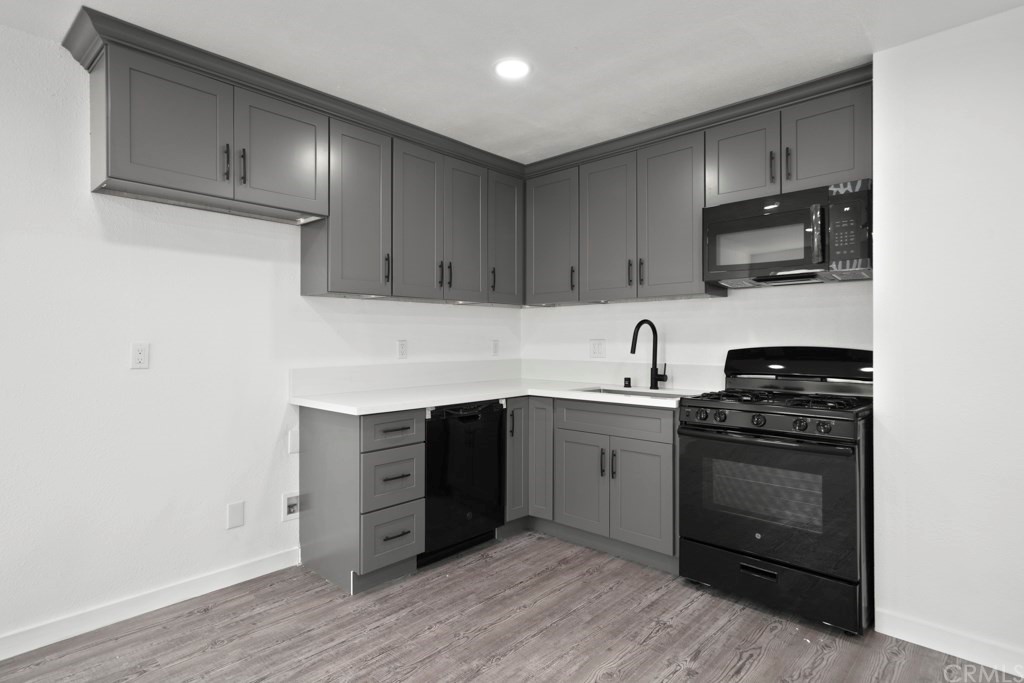 1202 Mahanna Avenue Long Beach, CA 90813 - Photo 11 of 32 a kitchen with stainless steel appliances granite countertop a stove and a sink