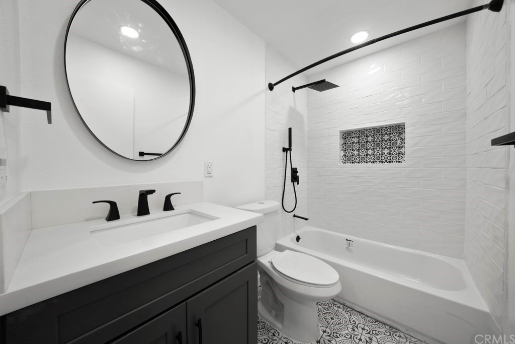 1202 Mahanna Avenue Long Beach, CA 90813 - Photo 18 of 32 a bathroom with a sink a toilet and a mirror