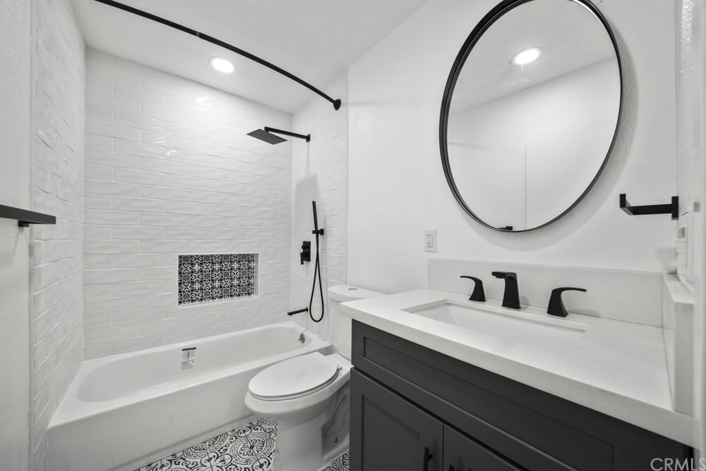 1202 Mahanna Avenue Long Beach, CA 90813 - Photo 21 of 32 a bathroom with a sink a toilet and a mirror