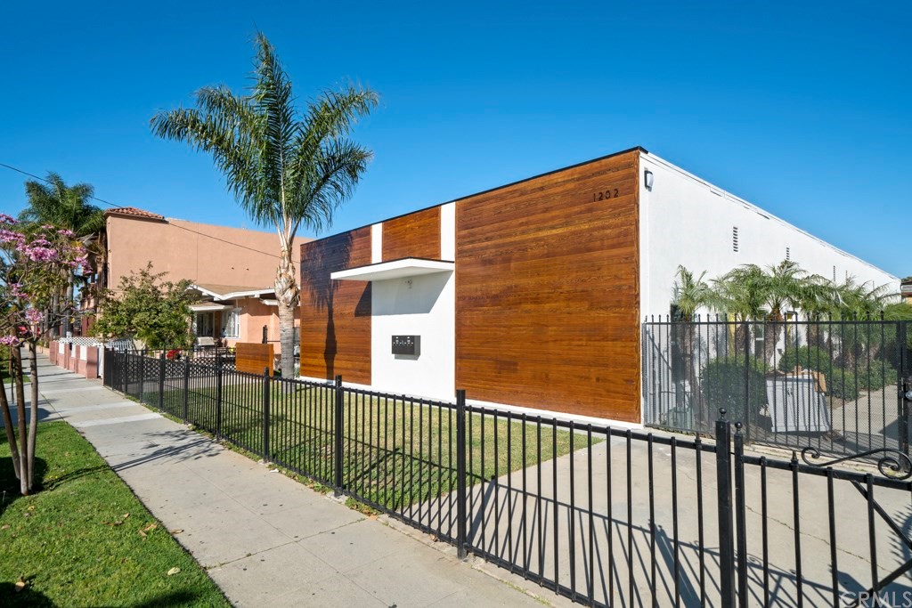 1202 Mahanna Avenue Long Beach, CA 90813 - Photo 29 of 32 a view of a pathway with a wrought fence