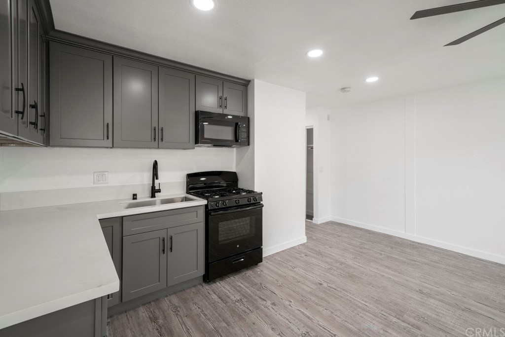 1202 Mahanna Avenue Long Beach, CA 90813 - Photo 10 of 32 a kitchen with stainless steel appliances granite countertop a sink stove and refrigerator
