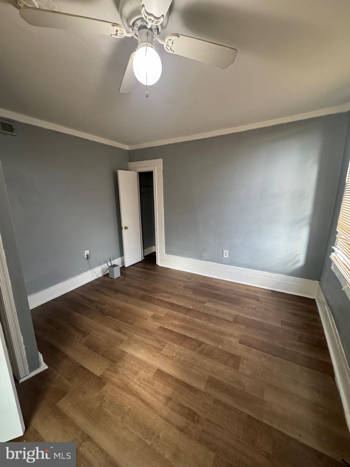 5000 Litchfield Avenue, Unit 1 Baltimore, MD 21215 - Photo 14 of 16 en empty room with wooden floor and fan