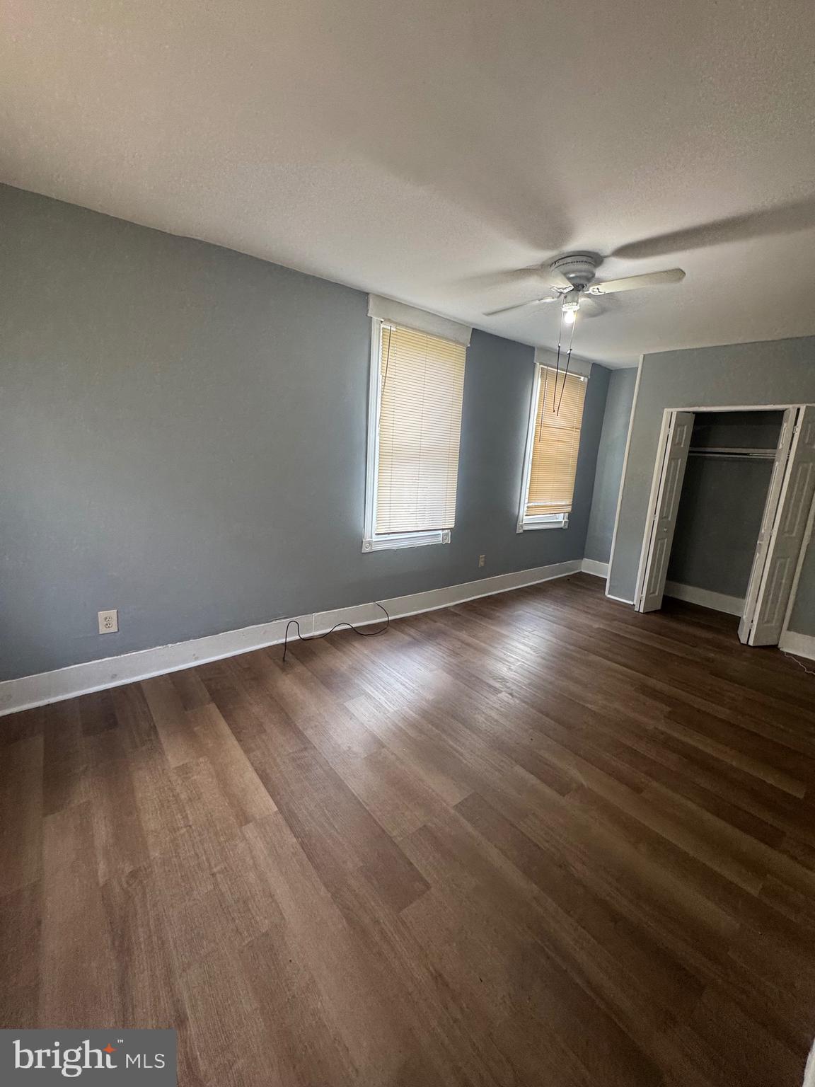 5000 Litchfield Avenue, Unit 1 Baltimore, MD 21215 - Photo 15 of 16 an empty room with wooden floor and windows