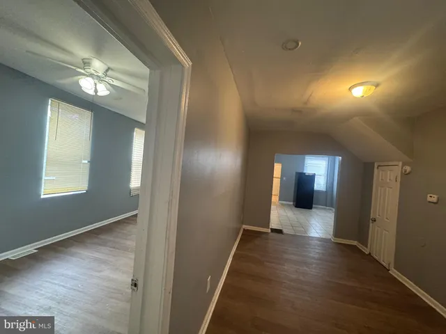 a view of a hallway with wooden floor