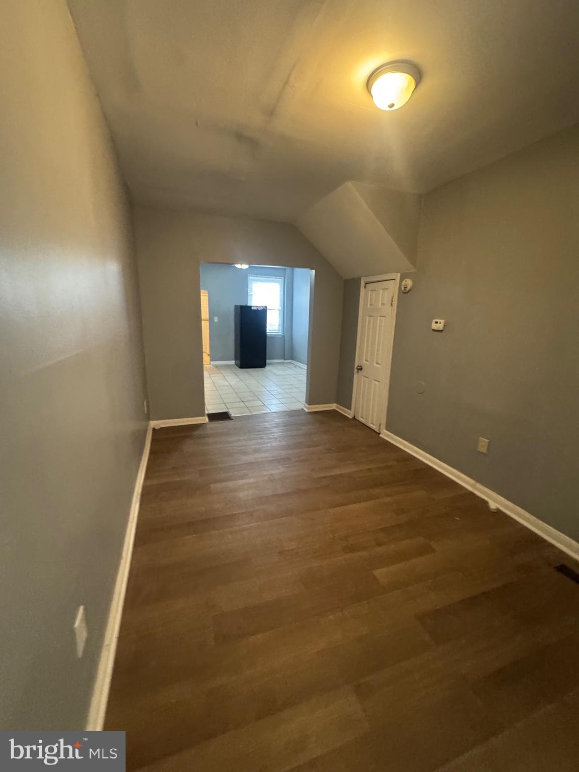 5000 Litchfield Avenue, Unit 1 Baltimore, MD 21215 - Photo 10 of 16 an empty room with wooden floor and windows