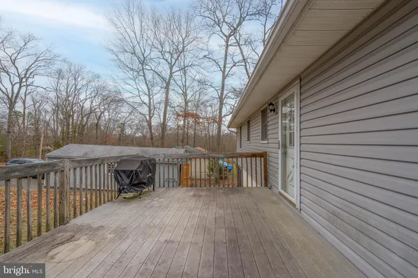 a view of backyard with deck and wooden floor