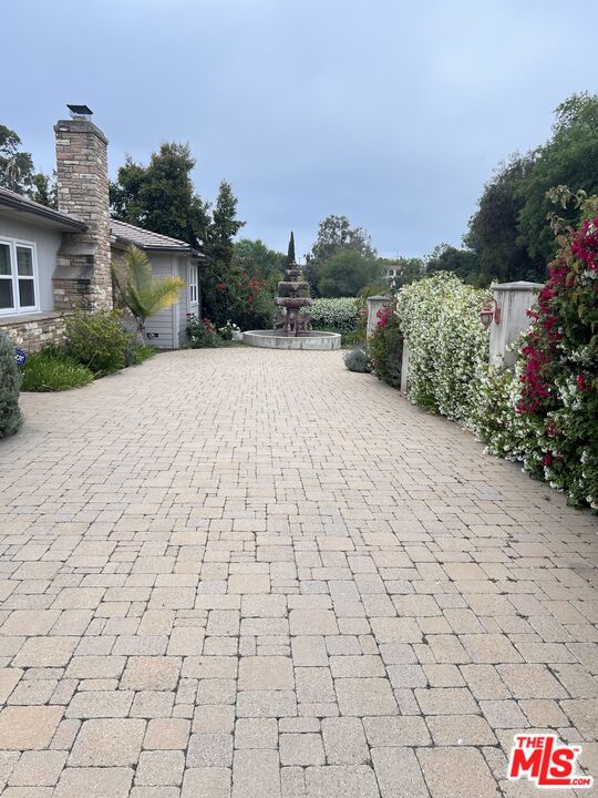 a pathway of a house with a yard