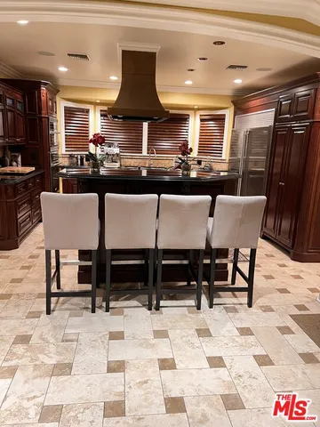 a stove top oven sitting inside of a kitchen