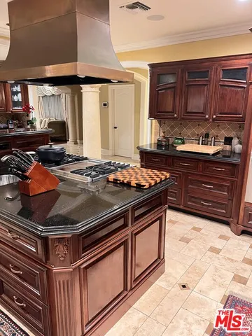a kitchen with stainless steel appliances granite countertop a stove and a sink