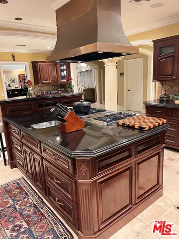 a kitchen with a sink stove and cabinets