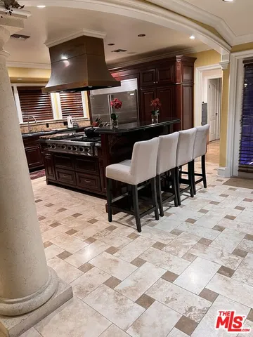 a kitchen with stainless steel appliances a stove a sink and a refrigerator