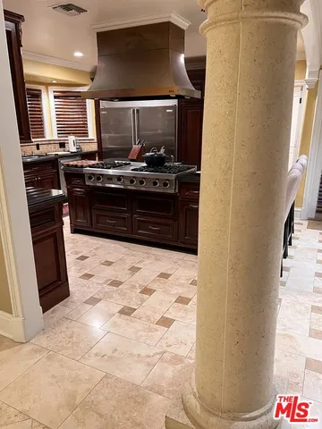 a kitchen with a stove and a refrigerator