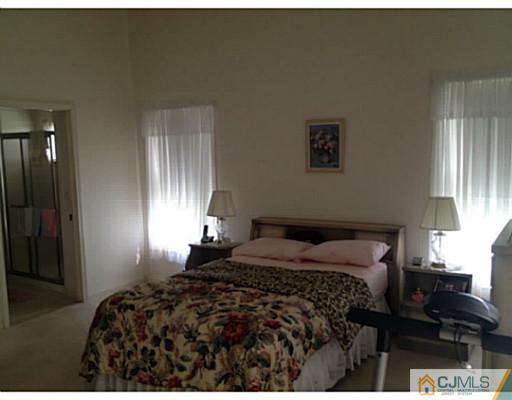 25 Riva Boulevard Brick, NJ 08723 - Photo 11 of 19 a bedroom with a bed window and wall painting