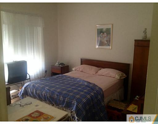 25 Riva Boulevard Brick, NJ 08723 - Photo 14 of 19 a bedroom with a bed and wooden floor