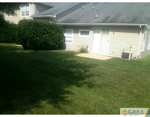 25 Riva Boulevard Brick, NJ 08723 - Photo 17 of 19 a front view of a house with a yard and garage