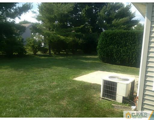 25 Riva Boulevard Brick, NJ 08723 - Photo 18 of 19 a backyard of a house with lots of green space