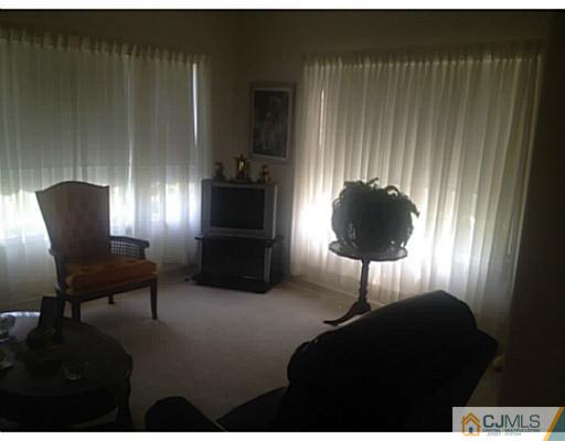 25 Riva Boulevard Brick, NJ 08723 - Photo 5 of 19 a living room with furniture and a lamp