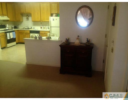 25 Riva Boulevard Brick, NJ 08723 - Photo 6 of 19 a kitchen with a sink and a refrigerator
